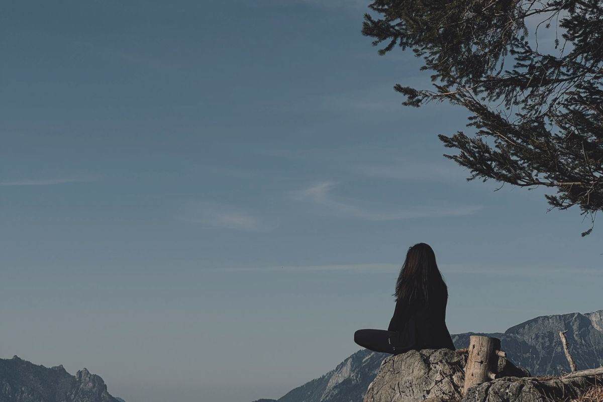 Care - DC couple sitting on the ground back to back