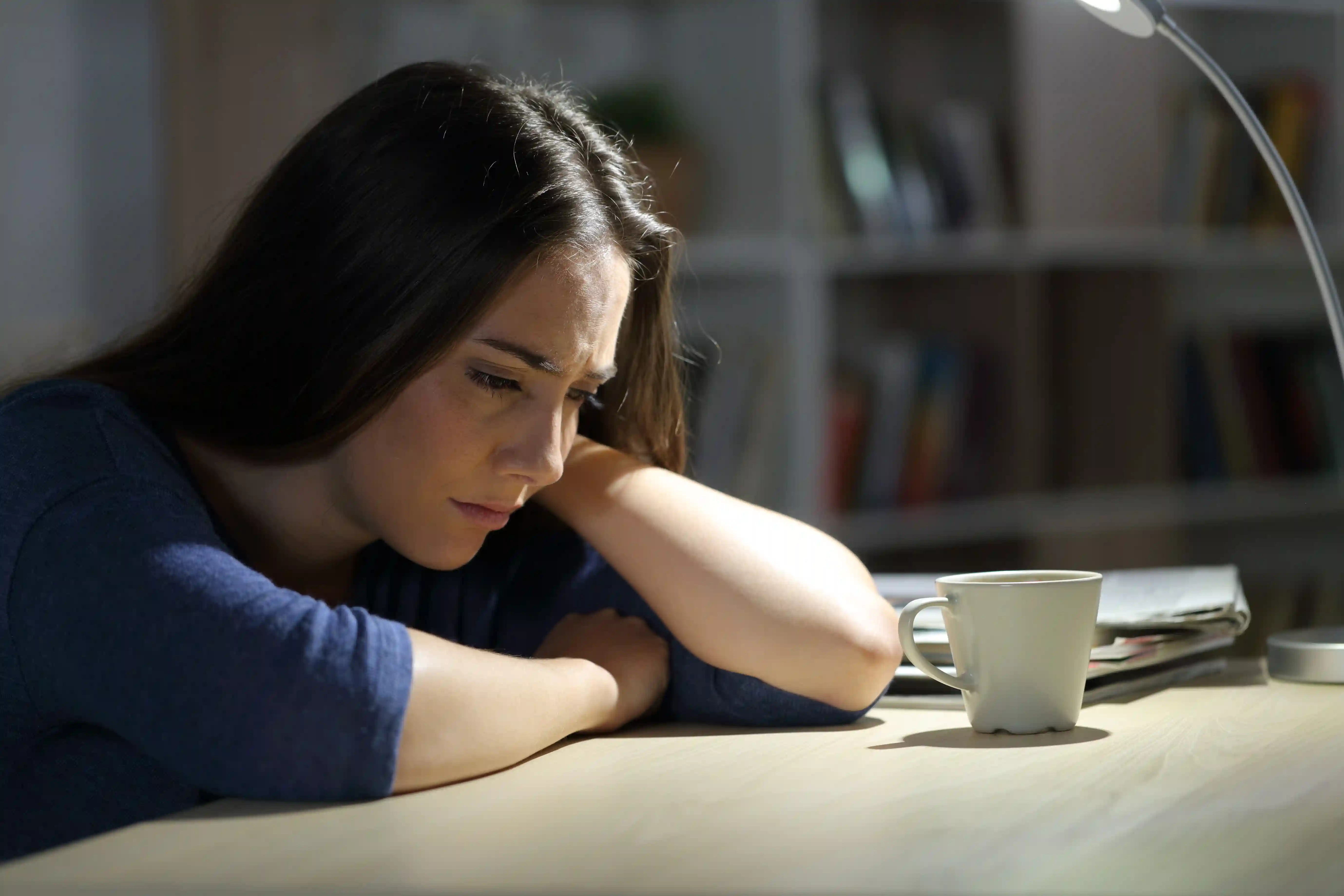 woman sitting alone and looking sad