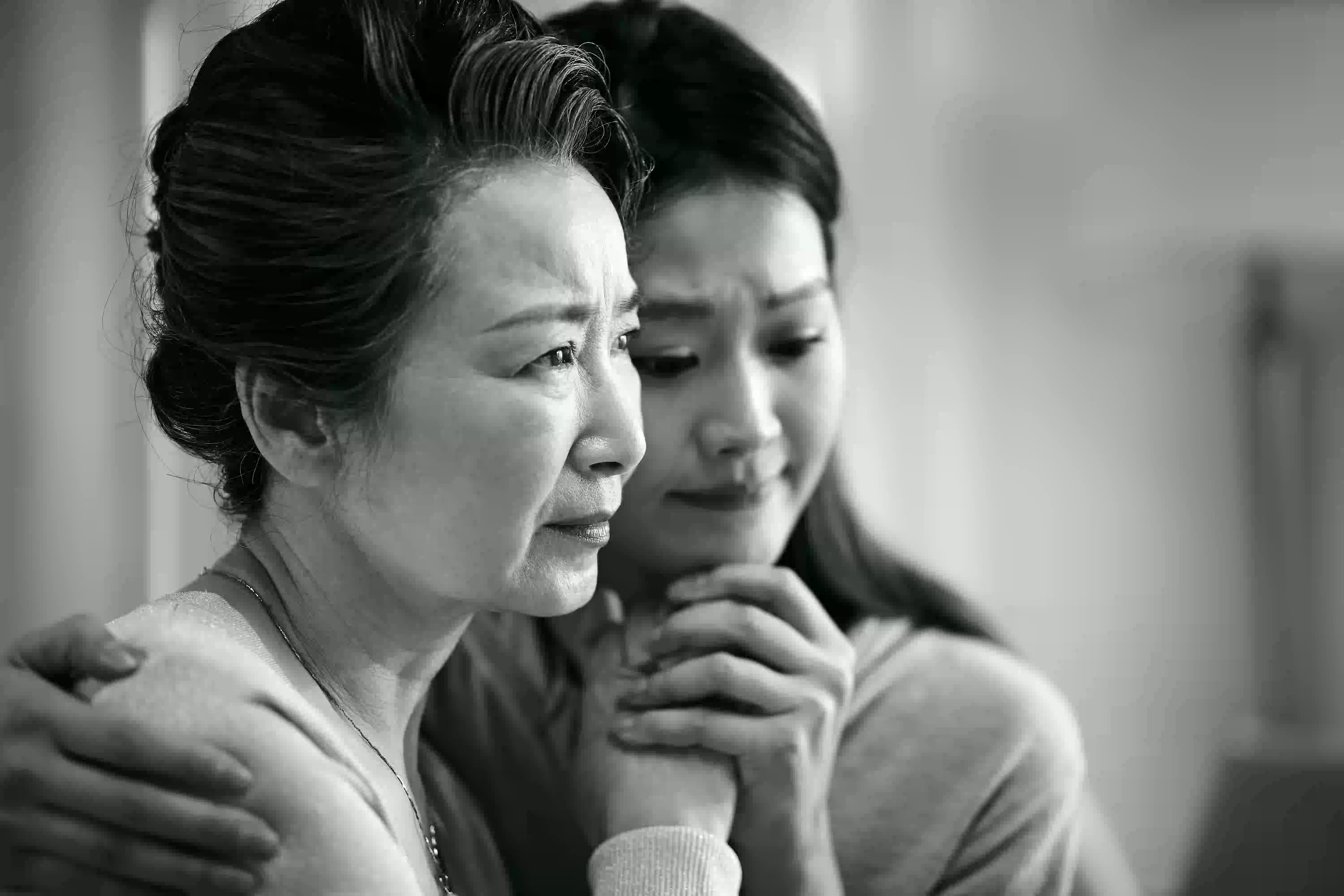 mother and daughter hugging with close face