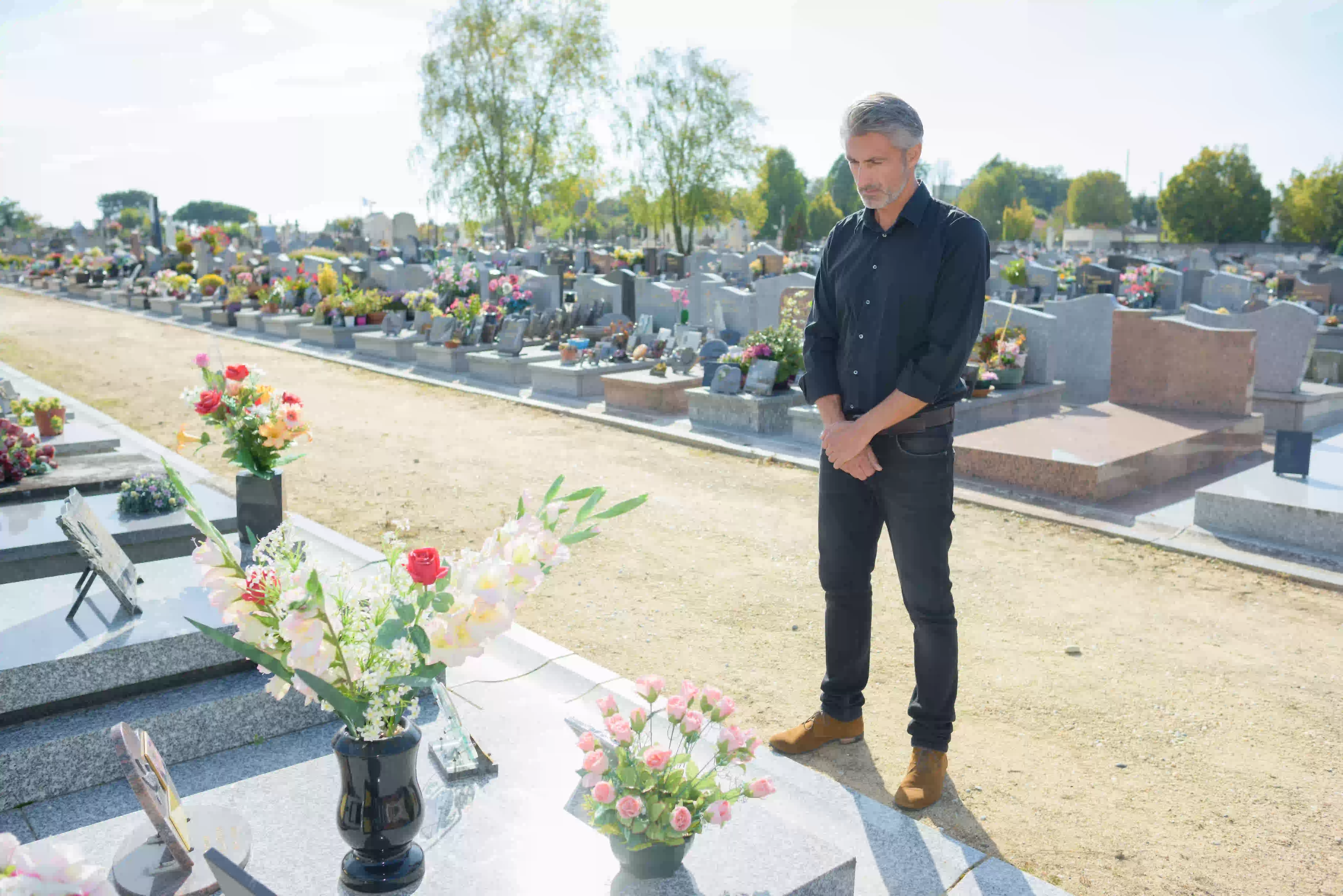 man standing in front of grave