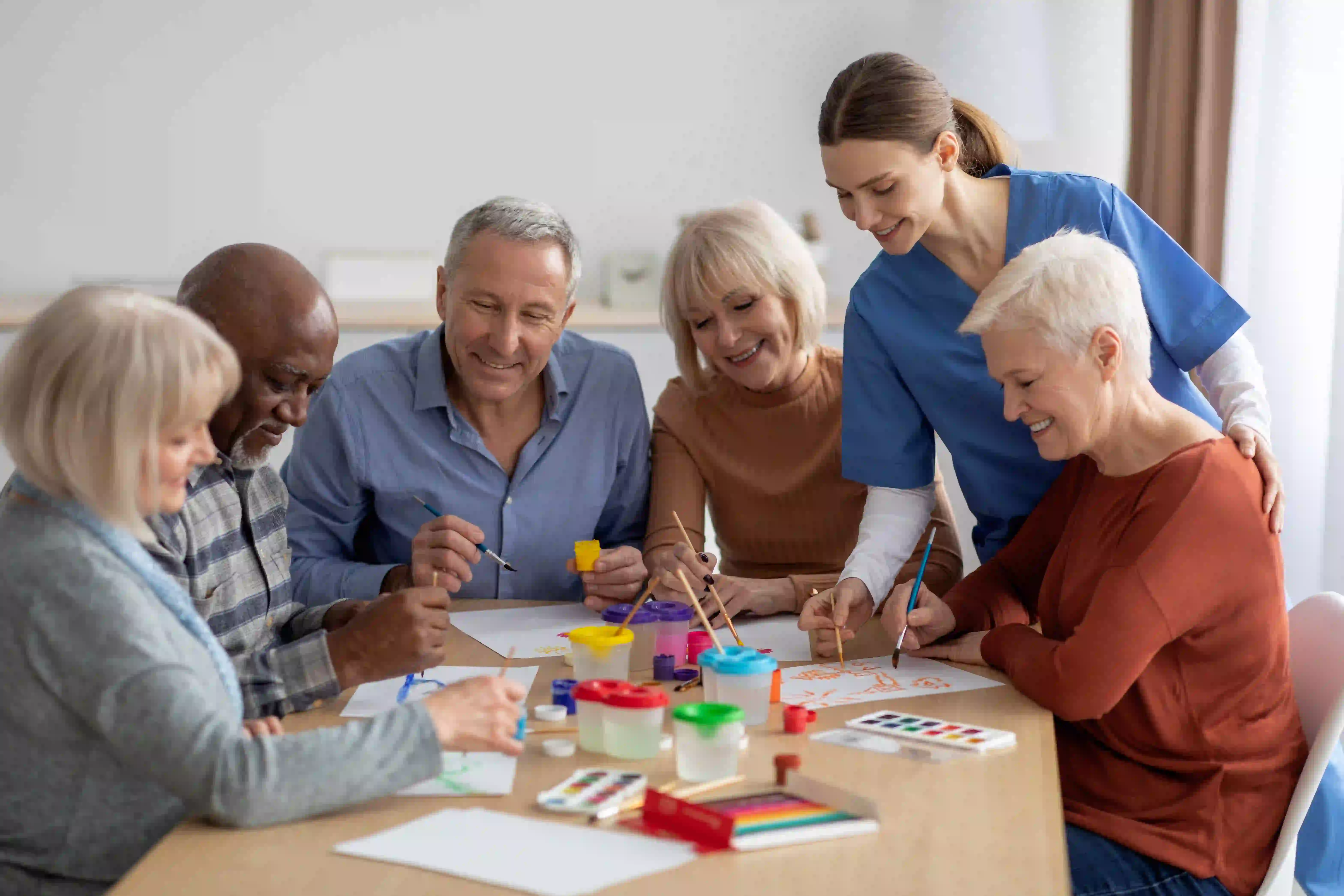 doing water color art with older people with one nurse