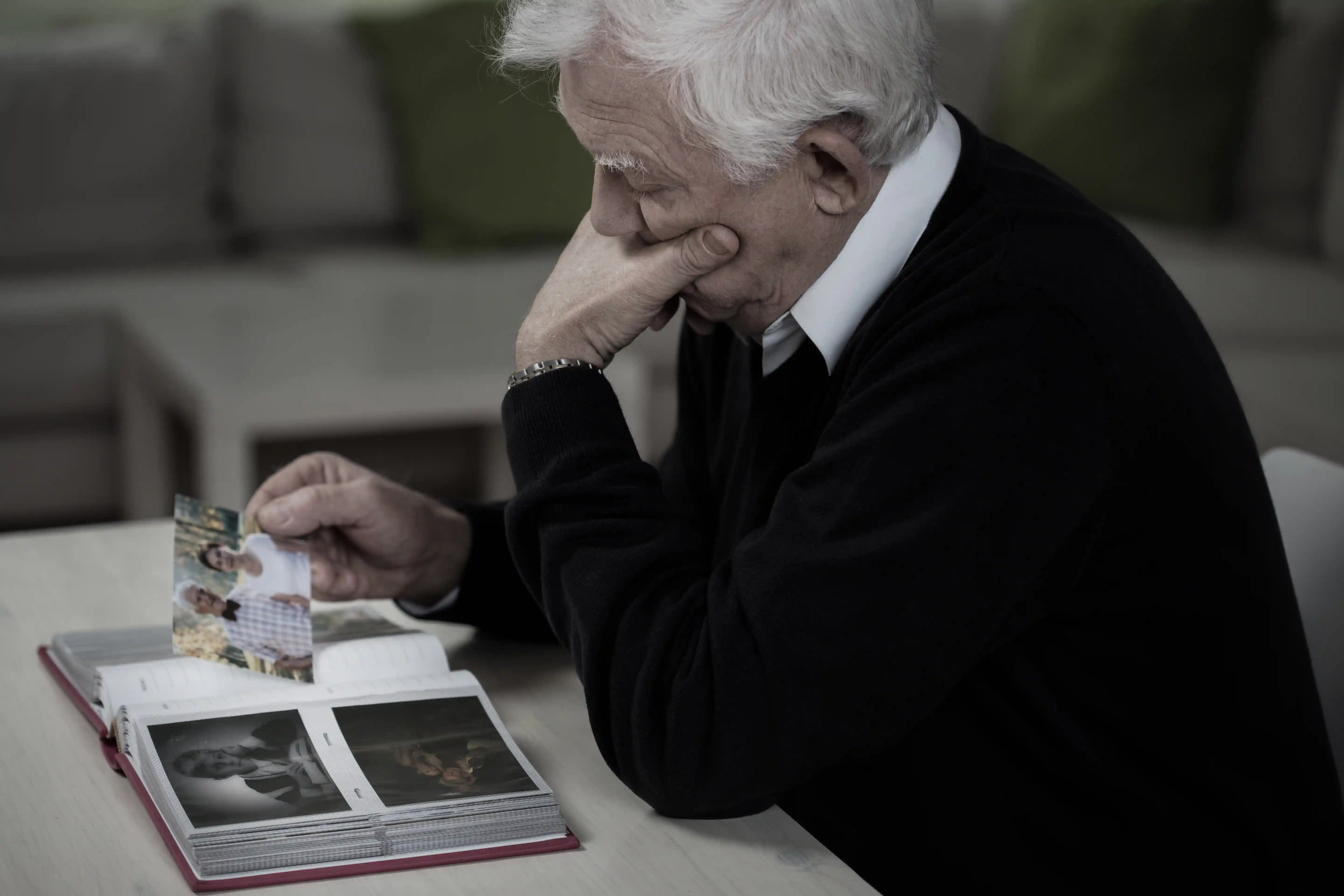 old man looking at photos